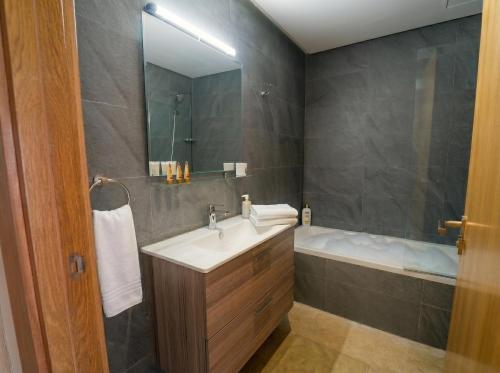a bathroom with a sink and a bath tub at Ocean View Duplex & Golf, Taghazout Bay in Tamraght Ouzdar