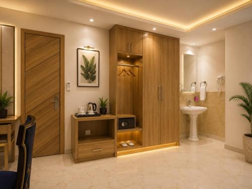 a bathroom with a toilet and a sink and a door at Hotel Decent Premier Suites Near Delhi Aerocity in New Delhi