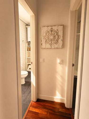 a hallway leading to a bathroom with a toilet at Callao Suites in Madrid