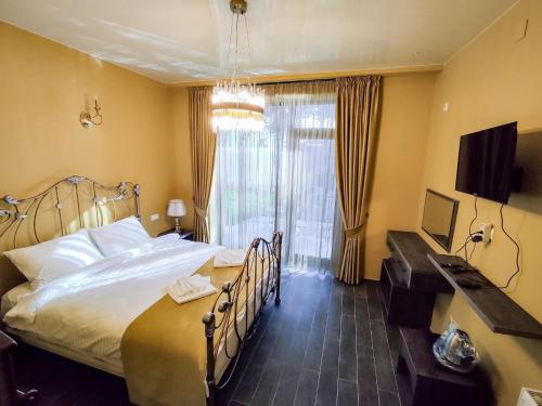 a hotel room with a large bed and a window at Villa MD Grigoleti in Grigoleti