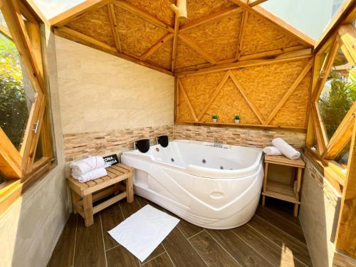 a bathroom with a large tub in a tent at Glamping Green Garden Suite in Villa de Leyva