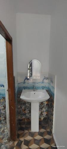 a bathroom with a white sink in a room at Bahram vatika in Sonprayag
