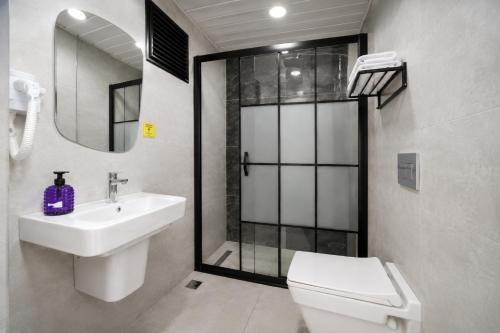 a bathroom with a toilet and a sink and a shower at Hotel Angel Beach - Kızkalesi Mersin in Erdemli