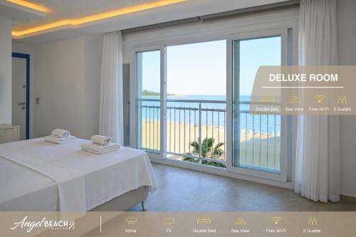 a hotel room with a bed and a large window at Hotel Angel Beach - Kızkalesi Mersin in Erdemli