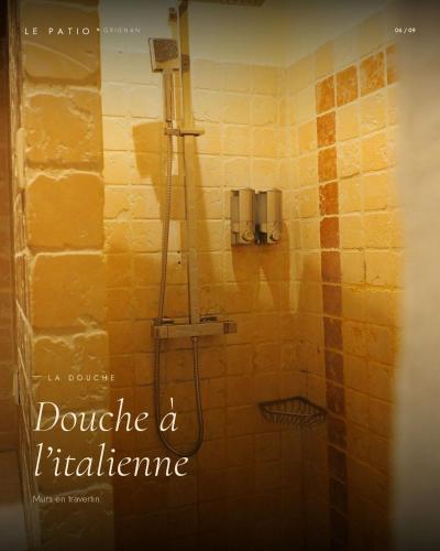 a shower in a tiled bathroom with the words donate a bathroom at LE PATIO in Grignan