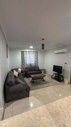 a living room with a couch and a table at Al-Dana 6 in Al Wajh