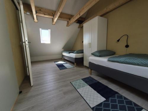 a room with two beds and two rugs in it at Boendgen's Ferienhaus mit Moselblick in Zell an der Mosel