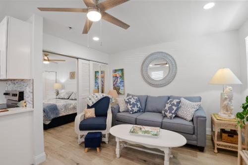 a living room with a couch and a table at Gulf Winds Resort by Travel Resort Services in St. Pete Beach