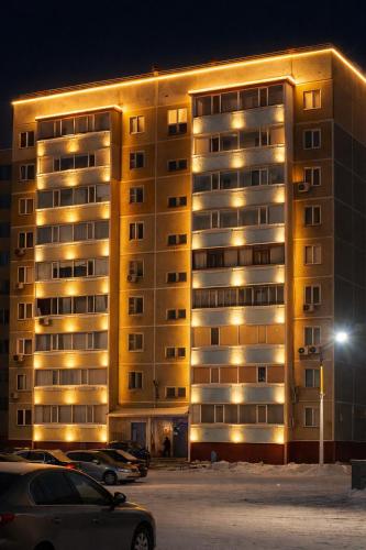 a large building with cars parked in front of it at Три богатыря in Līsakovsk