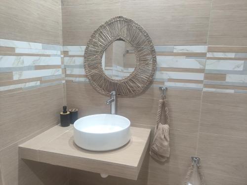 a bathroom with a white sink and a mirror at Casa de Playa in Salamina