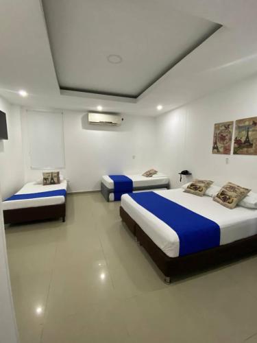 a bedroom with two beds in a room at Hotel Diamonds in Ríohacha