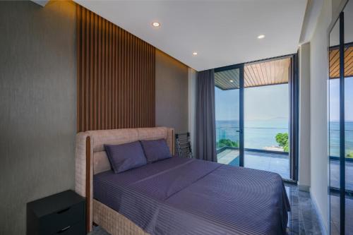 a bedroom with a bed with a view of the ocean at Bodrum Ada Suites Beach Hotel in Turgutreis