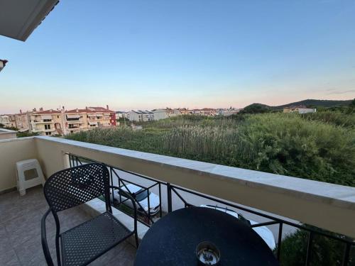 a balcony with a chair and a view of the ocean at Seaside Escape in Nea Peramos