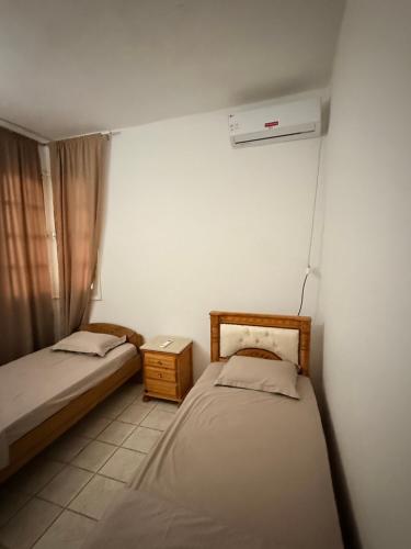a bedroom with two beds and a window at Villa rafraf in Rafrāf