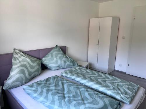 a bed with two pillows on it in a room at Ferienhaus Michi in Ursprung