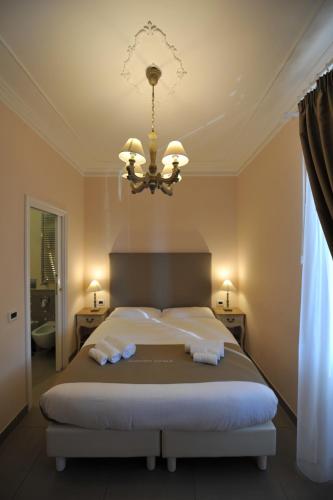 a bedroom with a large bed with towels on it at Villa Zaccardi in Rome