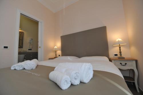 a bedroom with a bed with towels on it at Villa Zaccardi in Rome