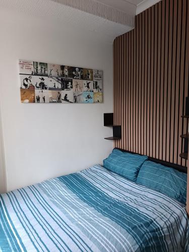 a bedroom with a bed with a blue comforter at Dover White Cliff Apartment in Dover