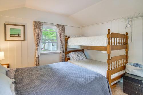 a bedroom with two bunk beds and a window at Charming Cape Cod Water-View Cottage in Mashpee