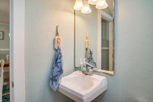 a bathroom with a sink and a mirror at Charming Cape Cod Water-View Cottage in Mashpee