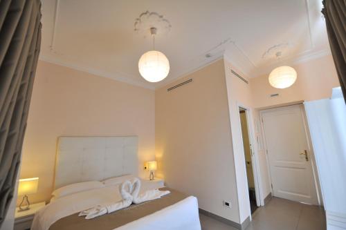 a bedroom with a bed with two towels on it at Villa Zaccardi in Rome