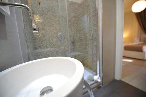 a bathroom with a white sink and a shower at Villa Zaccardi in Rome