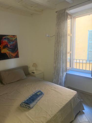 a bed in a bedroom with a large window at Jblago in Arona