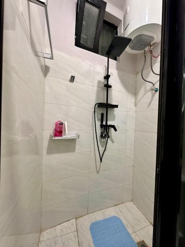 a bathroom with a shower with a tv on the wall at Hilm cottage in Āwasa