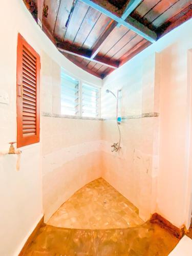 a bathroom with a shower and a sink at 9 bedroom Villa in Mombasa