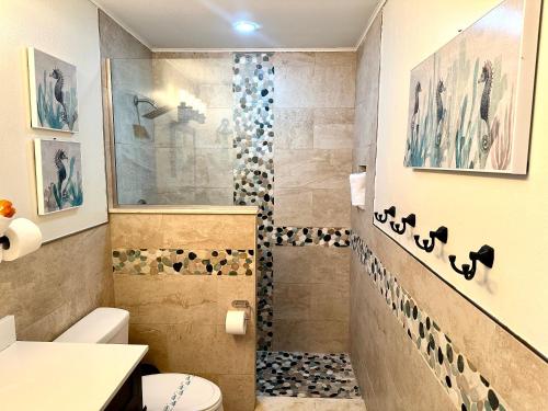 a bathroom with a shower and a toilet at Sunset by the Sea 3054 in Fort Myers Beach