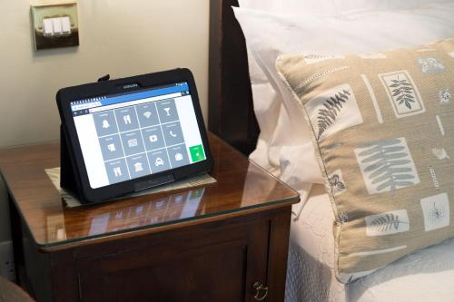 a tablet on a bedside table next to a pillow at Luxury Escape in Hunstanton