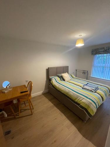 a bedroom with a bed and a desk and a table at CamCosy Retreat in Gortin