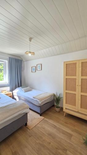 a bedroom with two beds and a ceiling at Baltic House in Kopalino