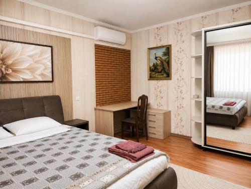 a bedroom with a bed and a desk at Apartment Casa de Bruja in Drochia