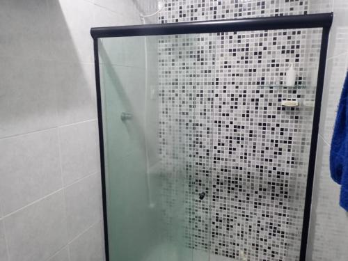 a shower with a glass door in a bathroom at recanto sossego in Garanhuns
