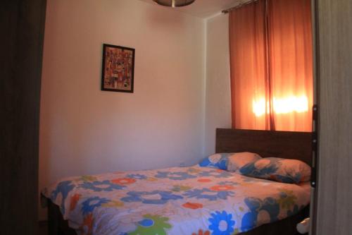 a bedroom with a bed with a colorful comforter at nKulle in Boge