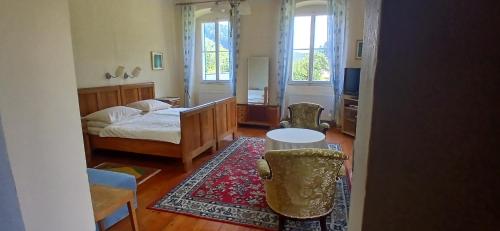 a bedroom with a bed and a table and chairs at Gasthaus Kopper in Guttaring