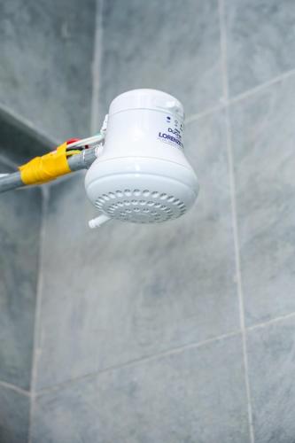 a toothbrush hanging from a holder in a bathroom at Onkundis Luxury Homes in Kiambu