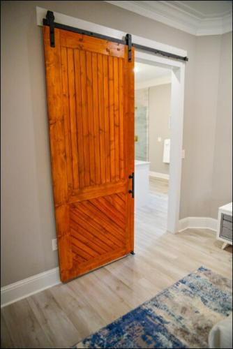 a wooden door in a room with a hallway at Luxe Dream Beach House in Gulfport