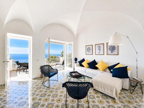 a living room with a couch and a table at Villa La Panoramica Sea View in Capri