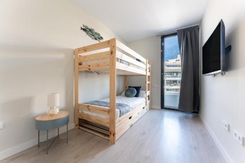 a bedroom with a bunk bed and a tv at Casa Miramar Oak 47 in Fuengirola