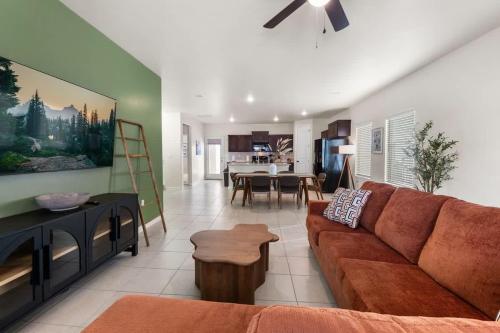 a living room with a couch and a dining room at Stylish 4BR Escape Open Layout Smart TVs A in El Paso
