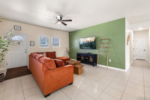 a living room with a couch and a ceiling fan at Stylish 4BR Escape Open Layout Smart TVs A in El Paso