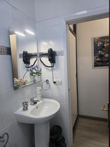 a white bathroom with a sink and a mirror at Medano Time in El Médano