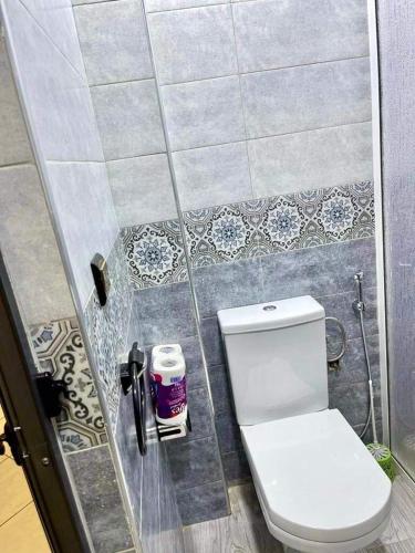 a bathroom with a white toilet in a shower at Las Brisas Beachfront Mekad private in Oued Laou