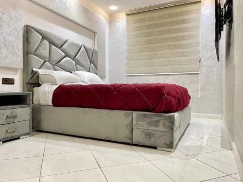 a bedroom with a large bed with a red blanket at Las Brisas Beachfront Mekad private in Oued Laou