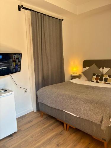 a bedroom with a bed and a television in a room at Sabah Homes in Antalya