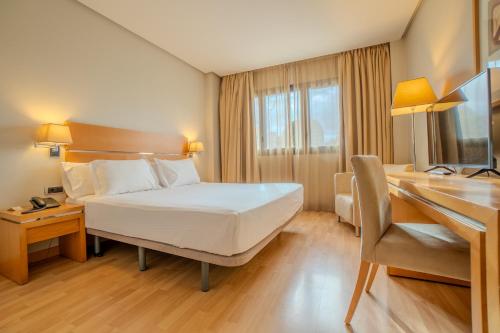 a hotel room with a bed and a desk at Hotel Reston Valdemoro in Valdemoro
