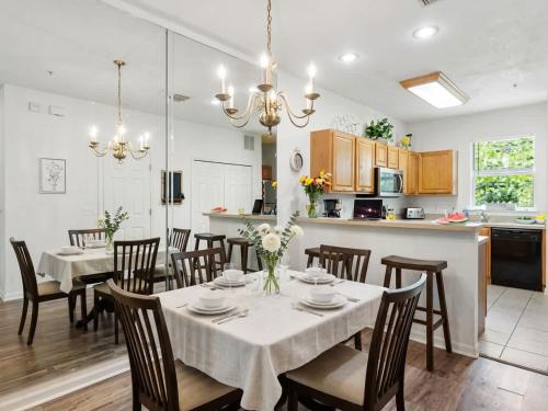a kitchen and dining room with a table and chairs at Convenient & Inviting - Fully-Equipped 2BD Condo in Gainesville