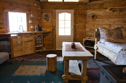a room with a bed and a table in a cabin at Agroturystyka Lasy Północy Leśna Chata in Dzierniakowo